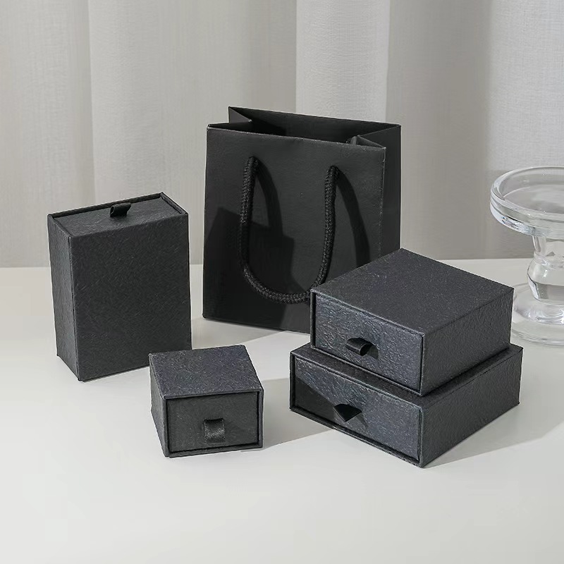 Black drawer jewelry boxes with matching rope-handle paper bag