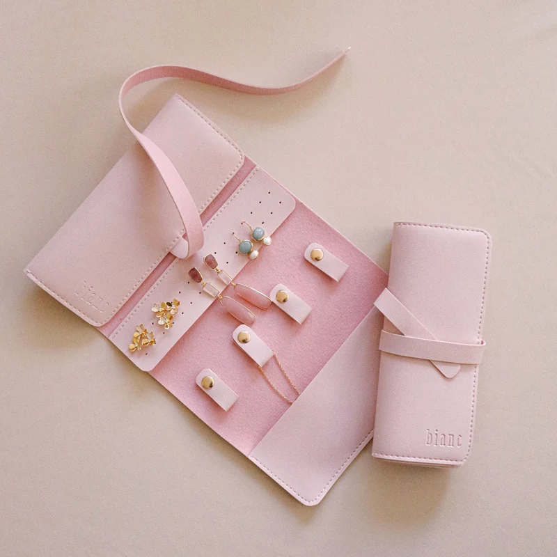 Pink microfiber jewelry roll with felt loop holders for rings and earrings