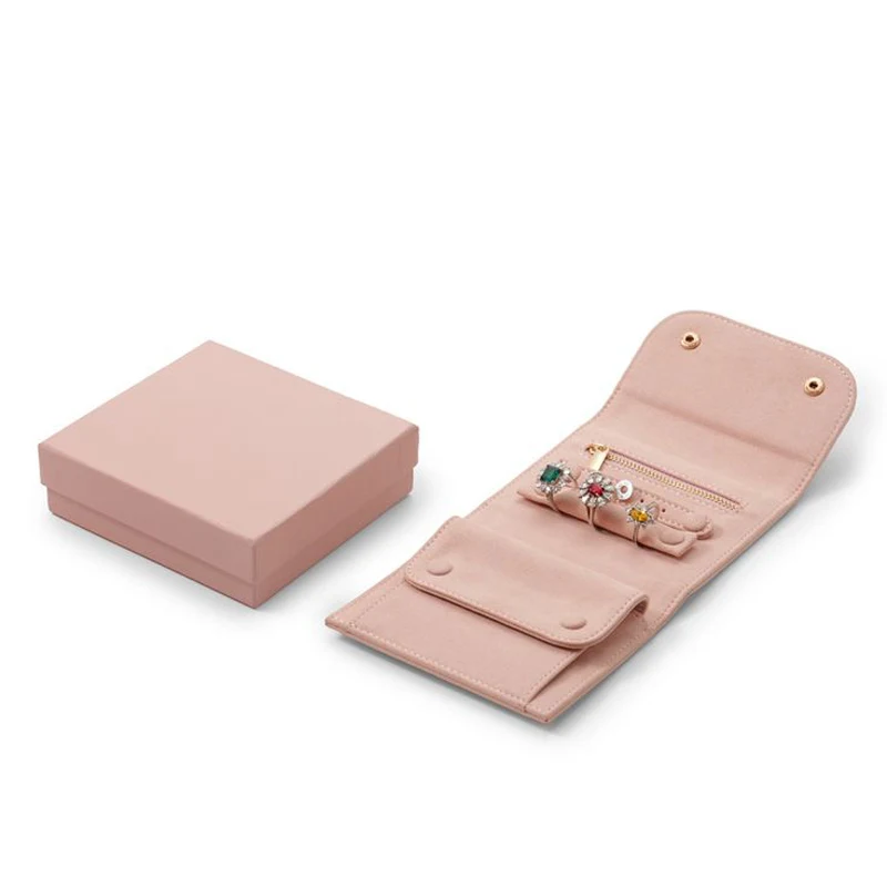 Pink microfiber jewelry roll with snap buttons and zip pocket, shown with matching gift box