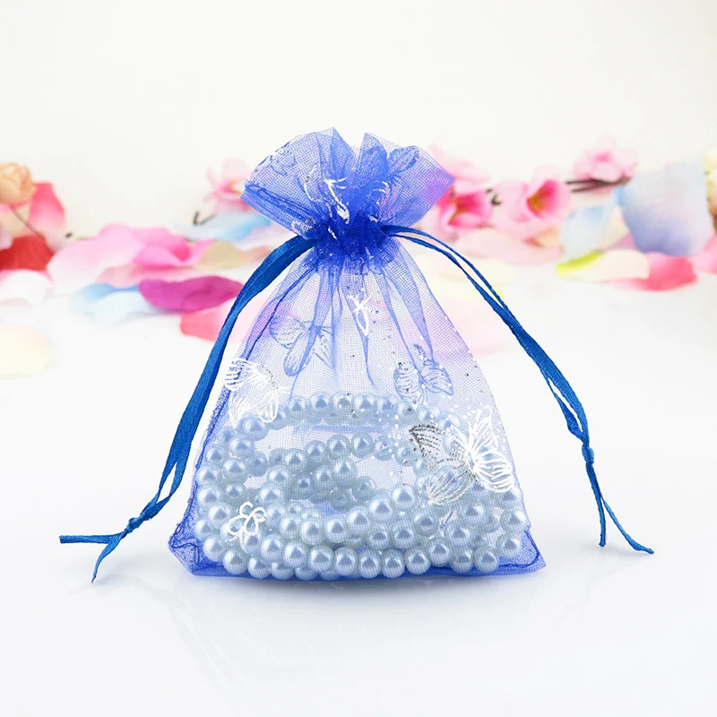 Blue butterfly-print organza pouch with pearl beads, styled with flower petals